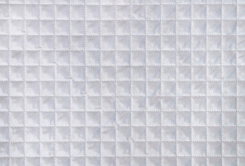 Fototapeta premium White fabric texture with checkered mesh embossing. Abstract material pattern, background or texture. Empty blank or template.