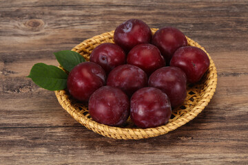 Plum heap in the wooden basket