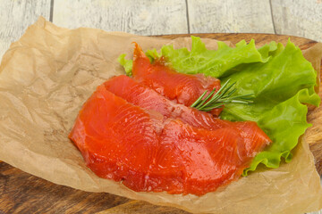 Sliced salmon fillet served rosemary