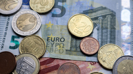 A few metal coins and paper notes of the European Union. Euro cash closeup.