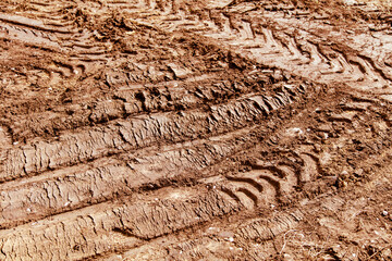 Traces of a truck on red soil.