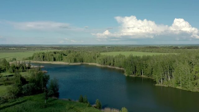 Tula oblast romantsevo hills and lakes drone aerial shot. Zoom in high quality 4k footage fly over tulskaya oblast romantsevskie hills, konduki shot under cloudy blue sky