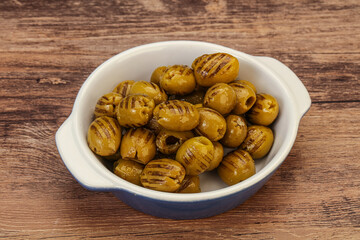Green grilled olives in the bowl