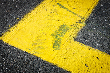 yellow color thermoplastic road marking paint. Marked parking space delineated by road surface markings, space for text, no people
