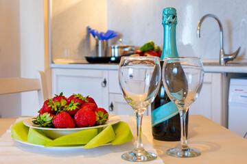 beautifully arranged table with strawberries and sparkling wine