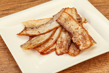 Roasted juicy bacon in the plate