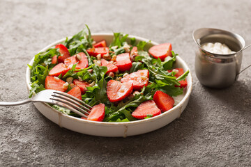 Strawberry salad with arugula and nuts. Healthy food. top view