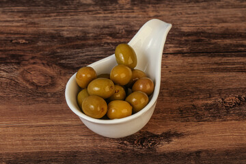 Green pickled olives in the bowl