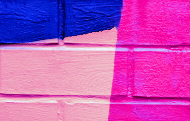 Beautiful bricks colorful street art graffiti background. Abstract spray drawing fashion colors on the brick walls of the city. Urban  orange , pink , purple , crimson, yellow , blue texture