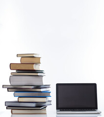 Elearning, books stack and a laptop isolated on white background