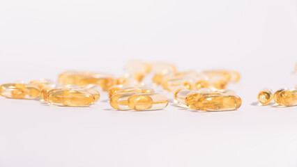 Omega 3 yellow soft gel pills isolated on white background.