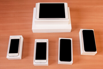 New technology on desk: different mobile phones generations, a tablet with boxes on desk
