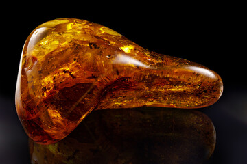 A piece amber on a black background.