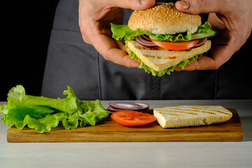 Burger with tofu in hands. Grilled Tofu Cheese. High quality photo