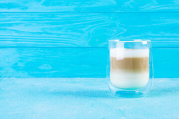 Cup of coffee macchiato. Hot drink coffee on blue background