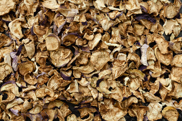 Dehydrated eggplants chunks background. Texture made of different heirlooms of dry aubergine. Vegetable chips.
