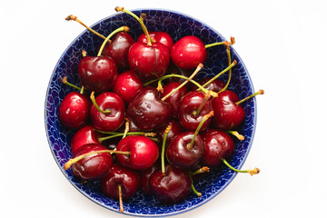 Fresh cherries in a blue bowl