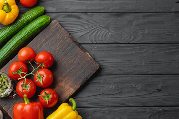 Top view of ripe vegetables on black wooden board