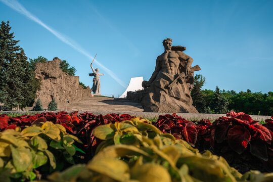 Beautiful panorama of Mamayev Kurgan in the city of Volgograd, photographed from under the blooming garden of flowers