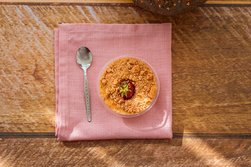 Milk pudding with strawberries and biscuit crumbs