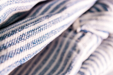 The close up of folding overalls with blue stripes pattern in sunlight.