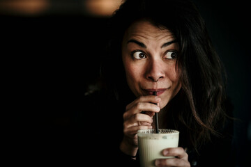 Europe, Germany, Berlin, beautiful woman is caffeinated by matcha latte.