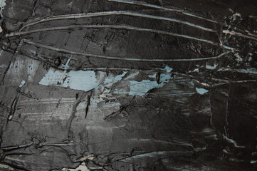 Dark gray concrete or textured putty with blue stains on the wall, background with copy space