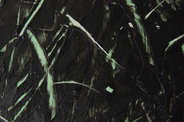 Dark gray concrete or textured putty with green stains on the wall, background with copy space