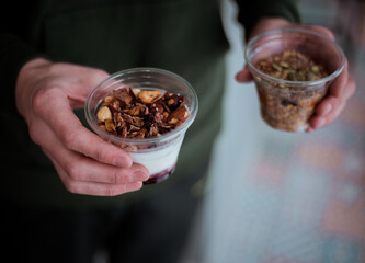 Desserts with nuts in hands, cafe background soft focus