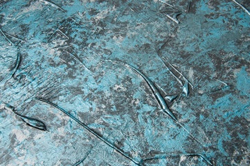 Blue concrete or textured putty with stains on the wall, background with copy space