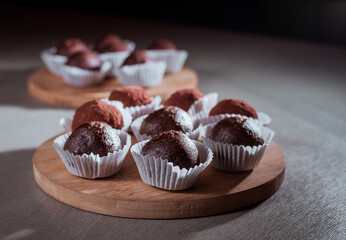 Chocolate truffles candy on wooden table, soft focus