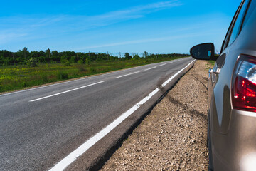 Panoramic photo of an empty highway with a piece of the car