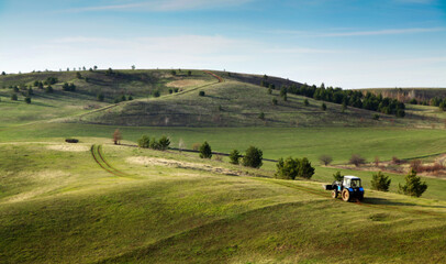 Obraz premium landscape with green hills and blue sky.
