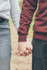 
Hands of a couple close-up in the forest