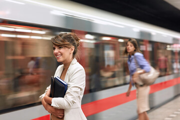 Smiling business  woman waiting for metro in subway.traveling at work.