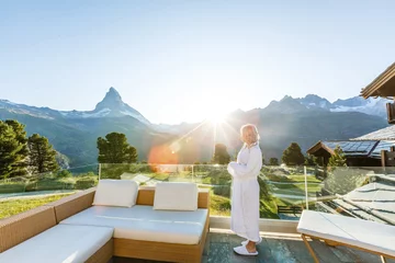 Foto op Canvas Woman enjoying the panoramic view from the pool in the alps © Angelov