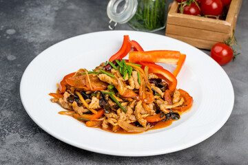 Meat with vegetables in a spicy sauce with fresh herbs