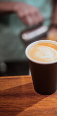 Cappuccino in cup on wood table