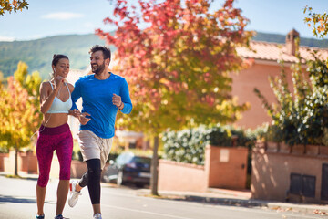 Fototapeta premium young caucasian couple working out, smiling, enjoying