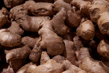 A pile of ginger root in the grocery store. Healthy natural product at the market place....