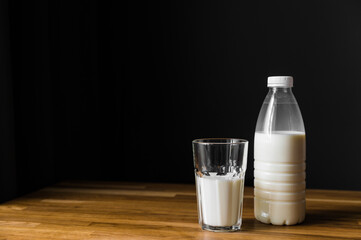 bottle of milk on the table and dark background