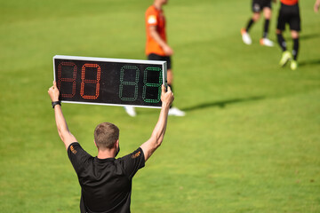 Technical referee shows 3 minutes added time during the football match.