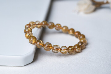 gem bracelet in front of white background 
