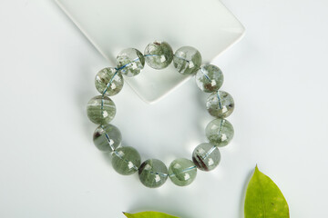 gem bracelet in front of white background 
