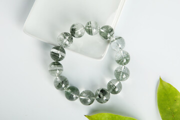 gem bracelet in front of white background 
