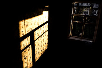 the sun shining through the window at sunset