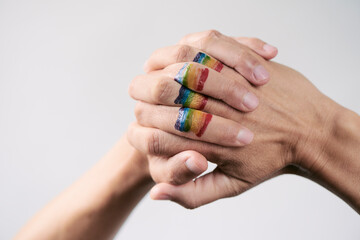 rainbow flag in the clasped hands of a person