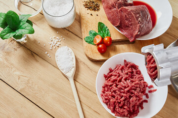 Chopped raw meat and ground beef . The process of preparing forcemeat by meat grinder. Top view.
