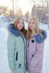 Asian girls in winter coats in a snowy city