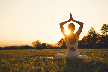 Young woman practicing yoga on nature.